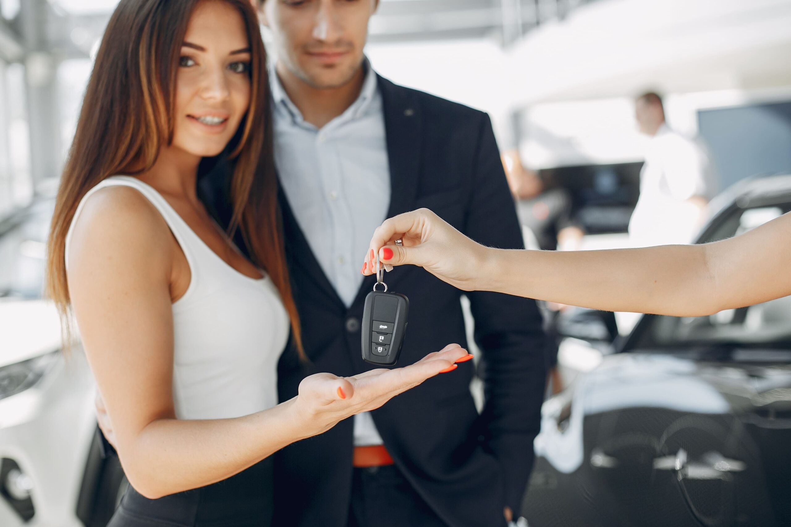 gente-con-estilo-y-elegante-en-un-salon-de-autos alquileres de carros en Aruba